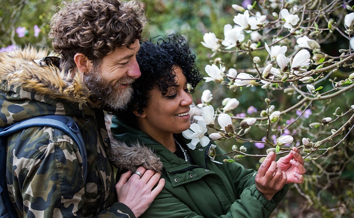 Couple walking through the arboretum in spring